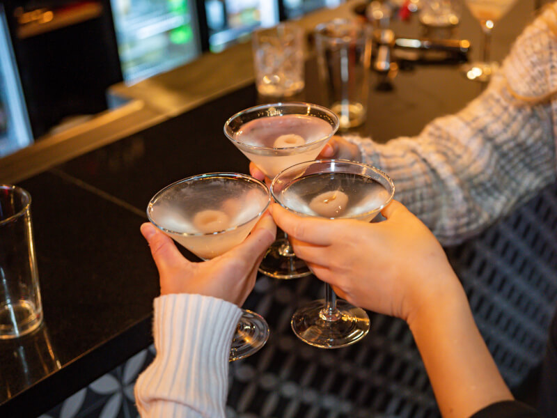 Three women clink cocktails for Mother's Day